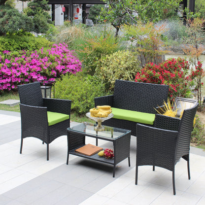 4 pc rattan patio furniture set with black wicker and green cushions around a glass table on Tampa Home & Garden Store