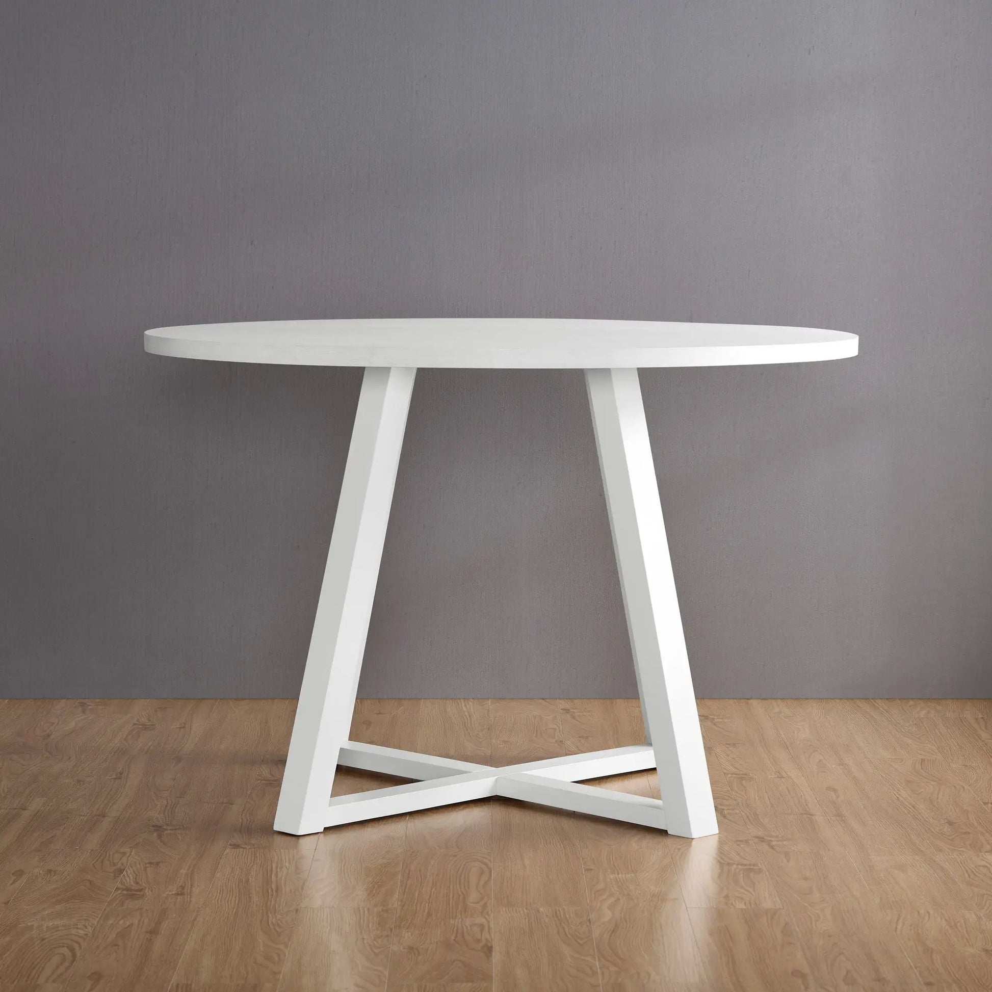 Edo white trestle dining table with angular legs by Unique Piece Furniture against a gray wall on Tampa Home & Garden Store