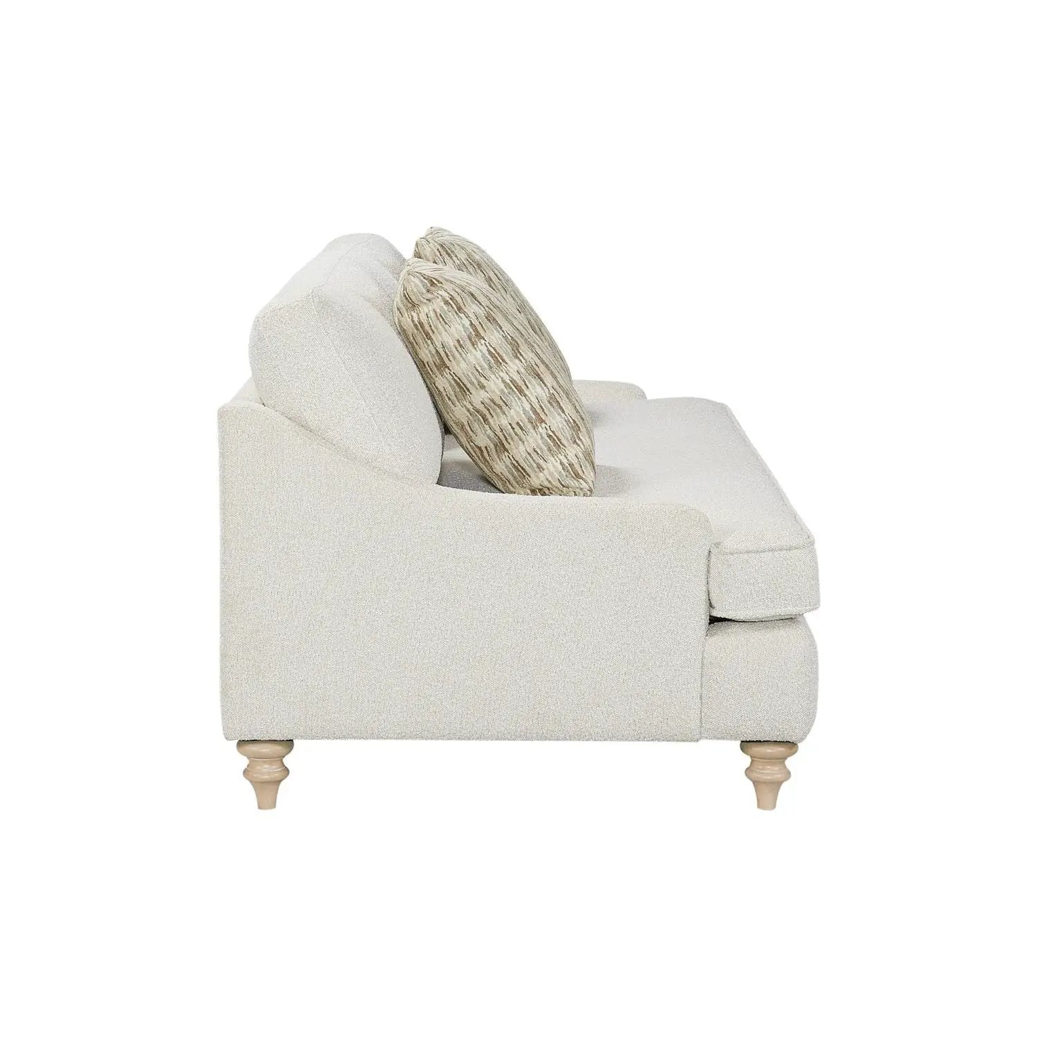 Single off-white fabric sofa with two decorative pillows and turned wooden legs on Tampa Home & Garden Store
