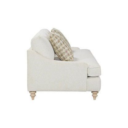 Single off-white fabric sofa with two decorative pillows and turned wooden legs on Tampa Home & Garden Store