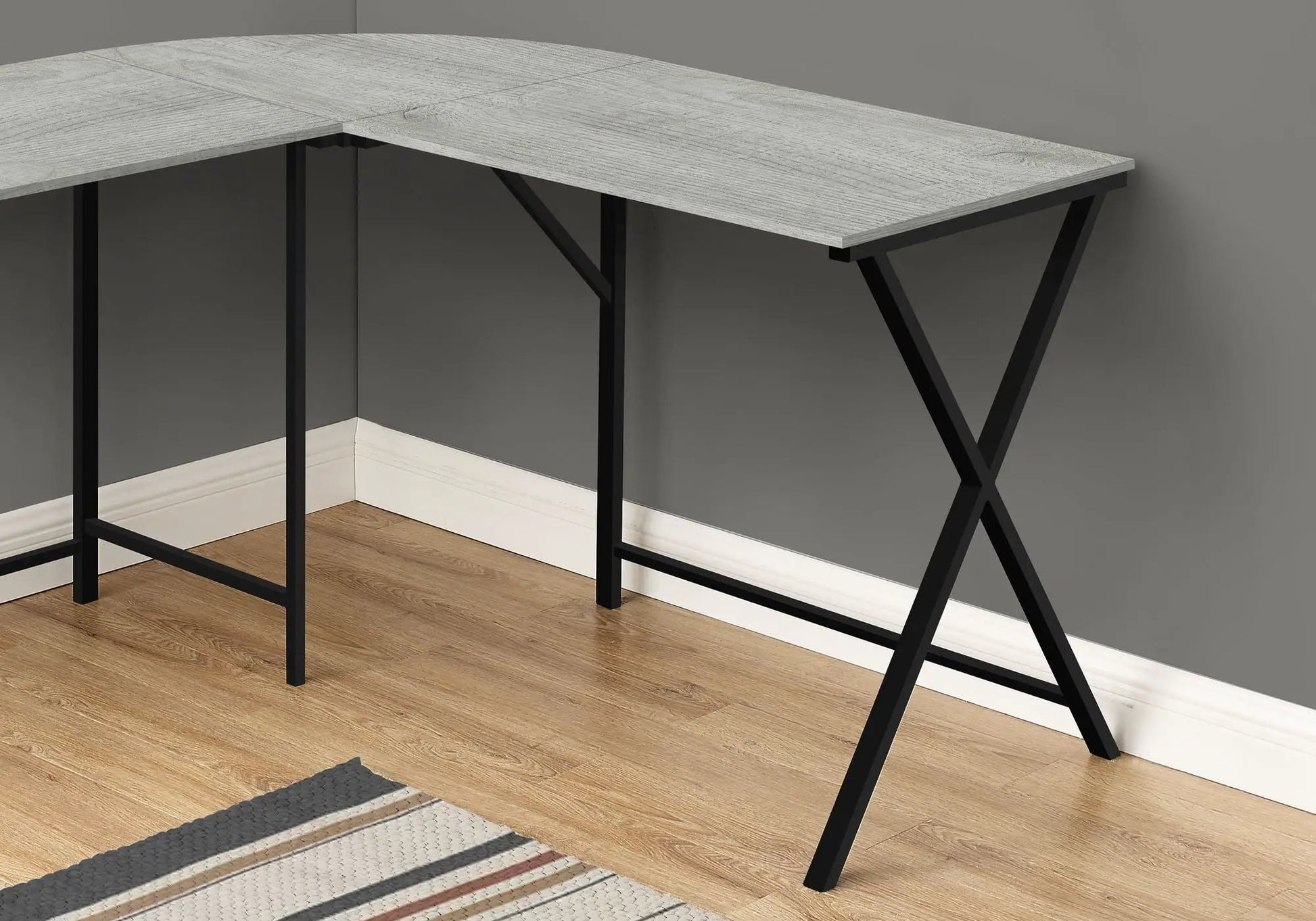 L-shaped corner computer desk with grey woodgrain top and black metal X-brace legs on Tampa Home & Garden Store