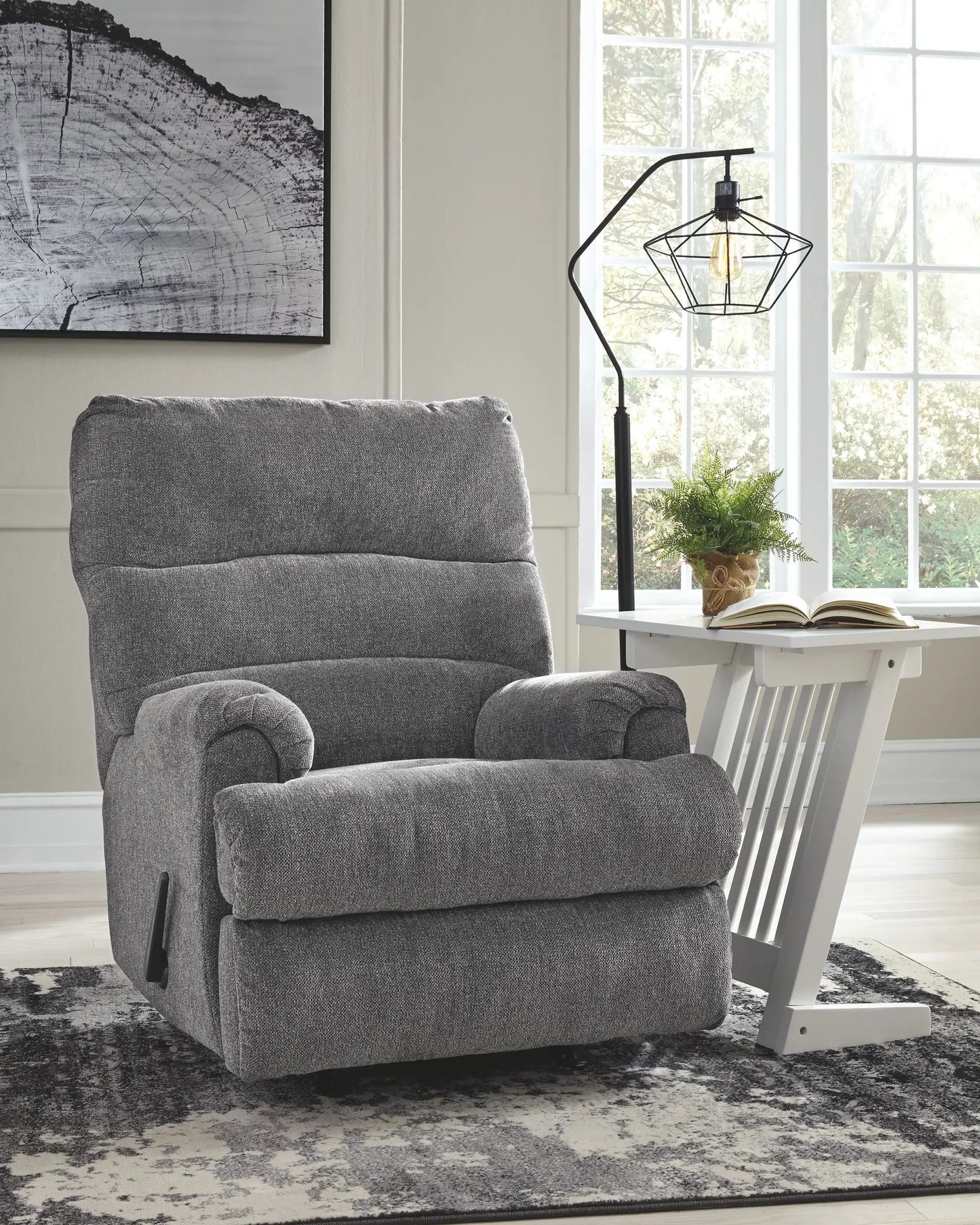 Man Fort Rocker Recliner in gray fabric beside a white desk and modern geometric lamp on Tampa Home & Garden Store