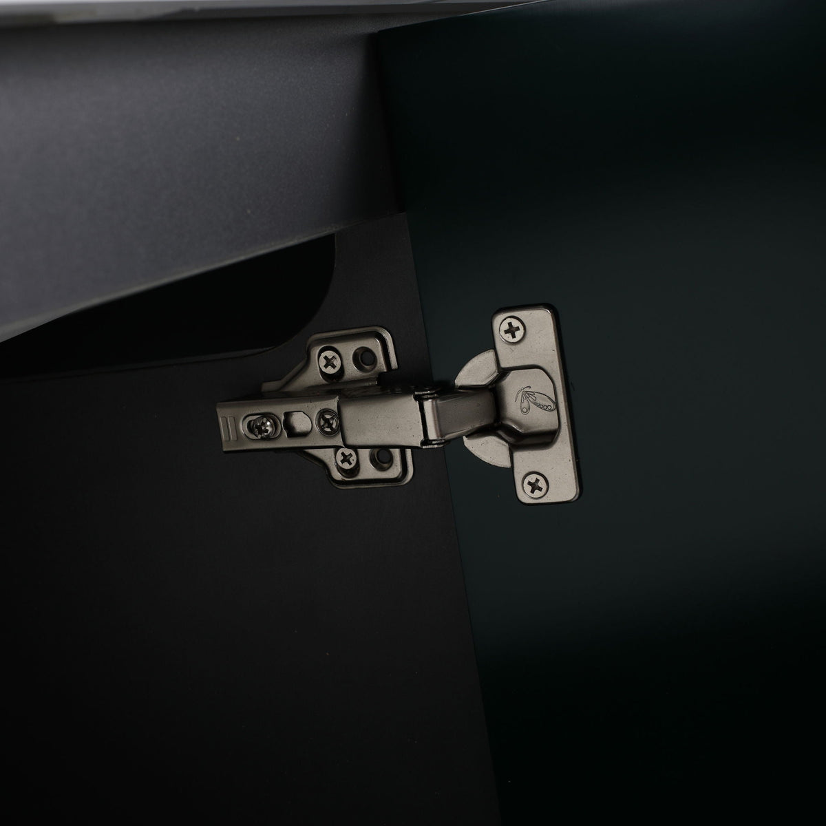 Freestanding bath vanity interior showing metal door hinge hardware in dark finish on Tampa Home & Garden Store