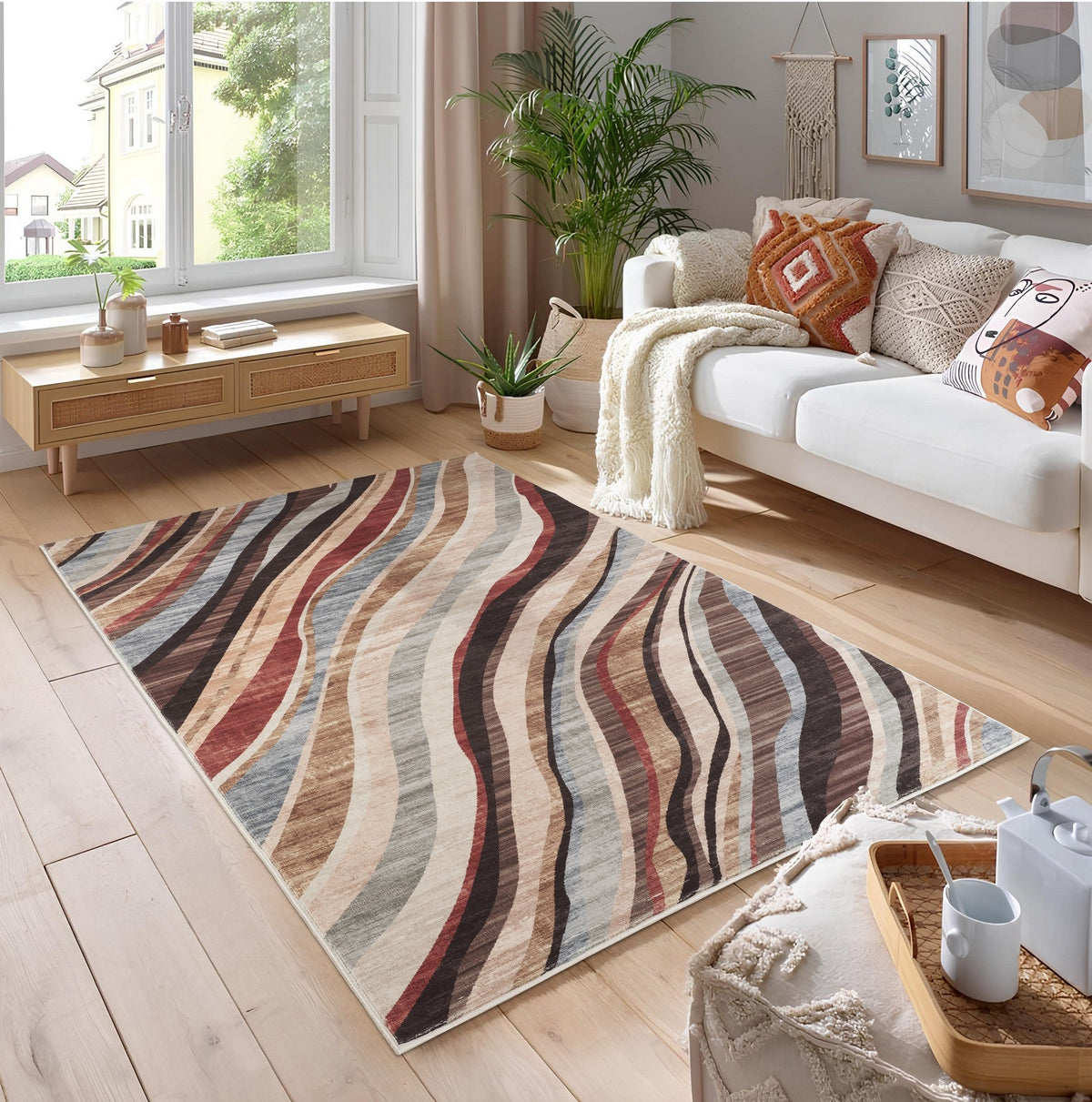 Modern polyester rug with bold multicolor waves on light hardwood in a bright living room on Tampa Home & Garden Store
