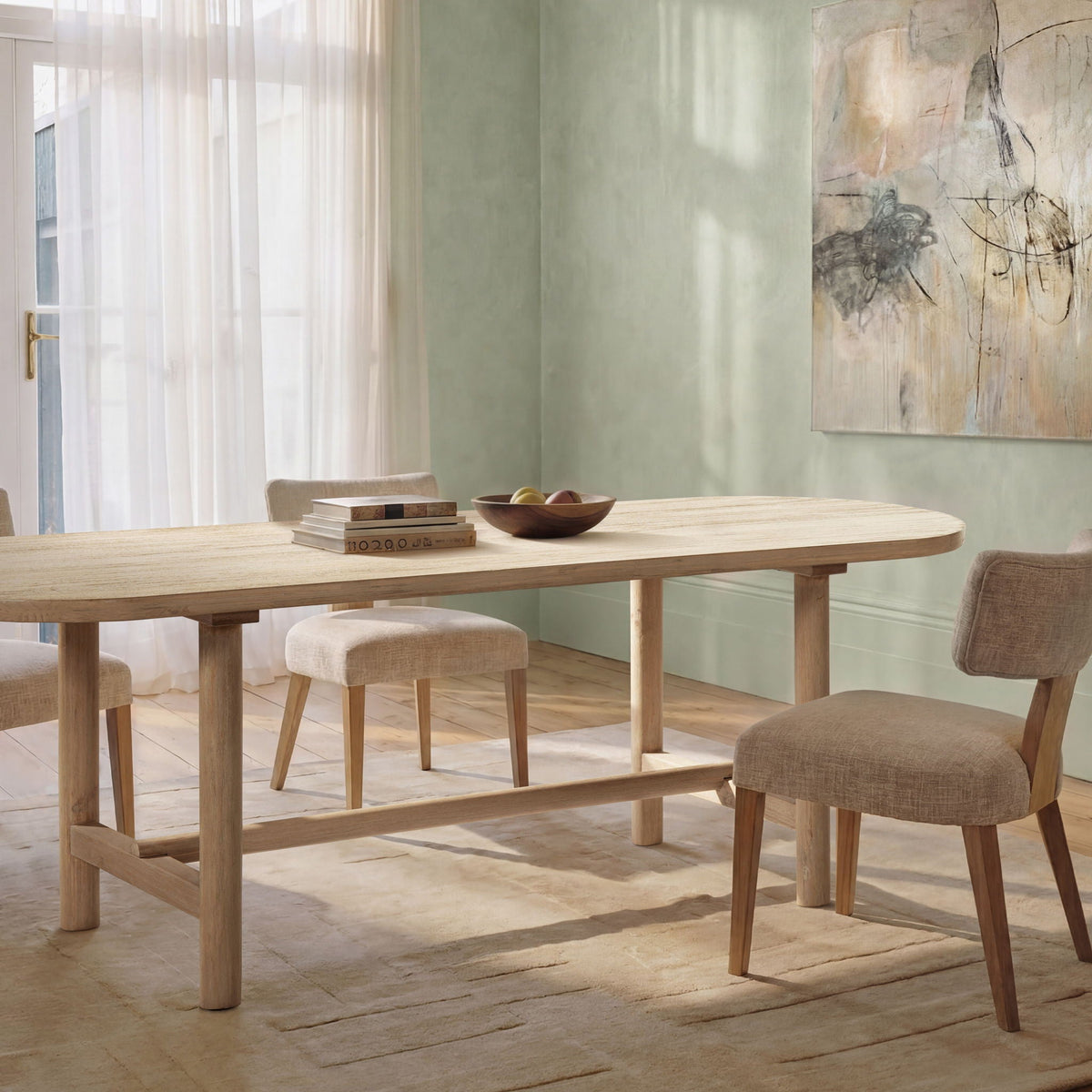 8-seat oval dining table in natural reclaimed pine with benches in a bright dining room on Tampa Home & Garden Store
