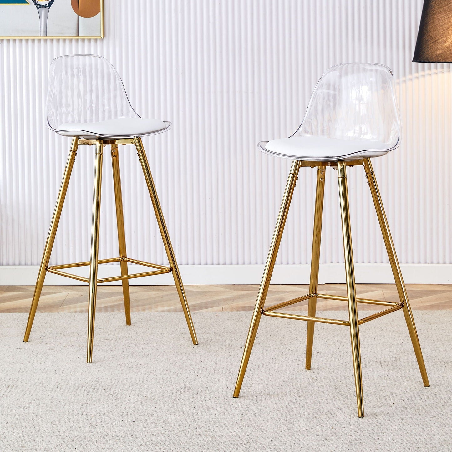 Two stylish upholstered bar chairs with clear shells, white cushions, and gold metal legs on Tampa Home & Garden Store