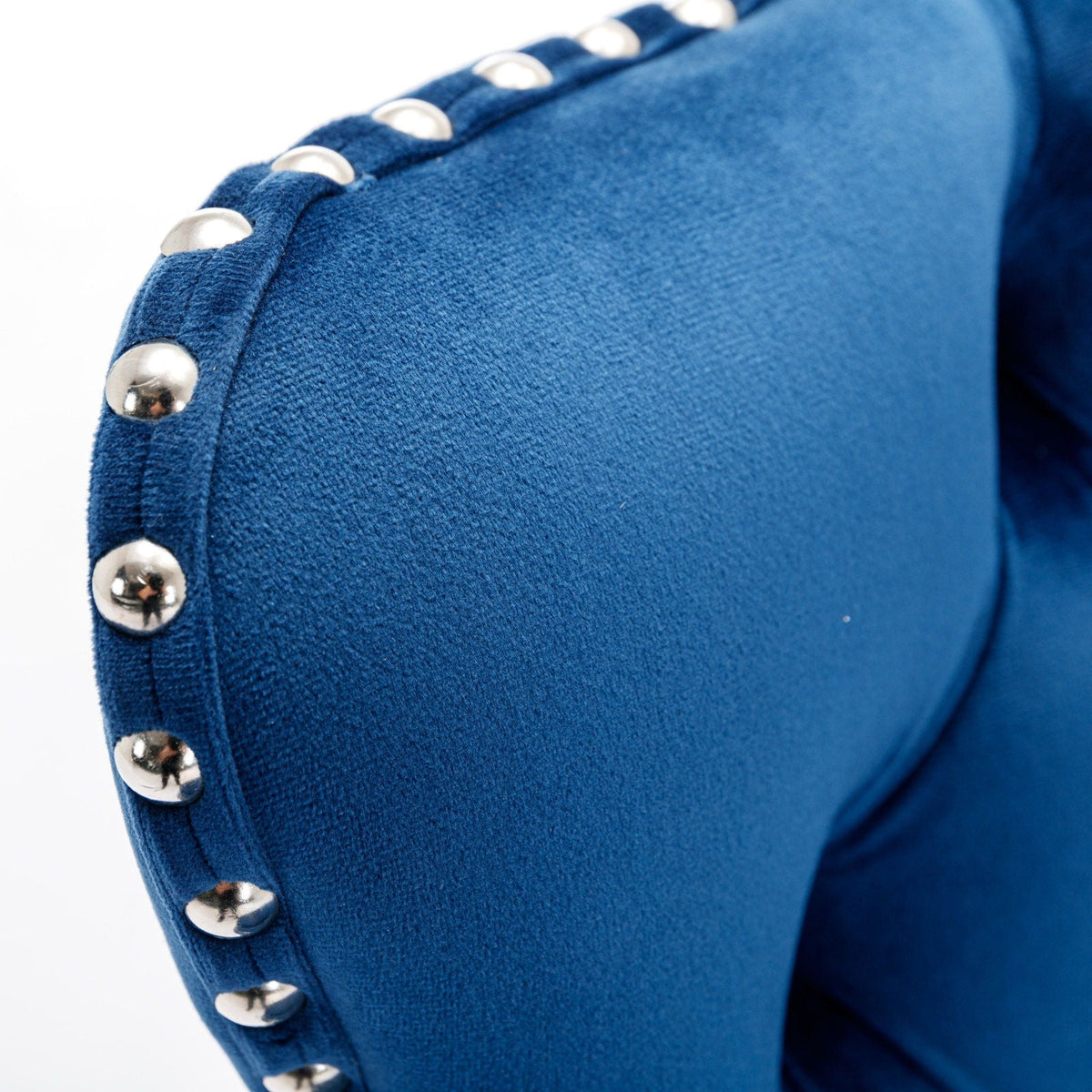 Blue velvet barstool upholstery with silver dome studs along seam on Tampa Home & Garden Store