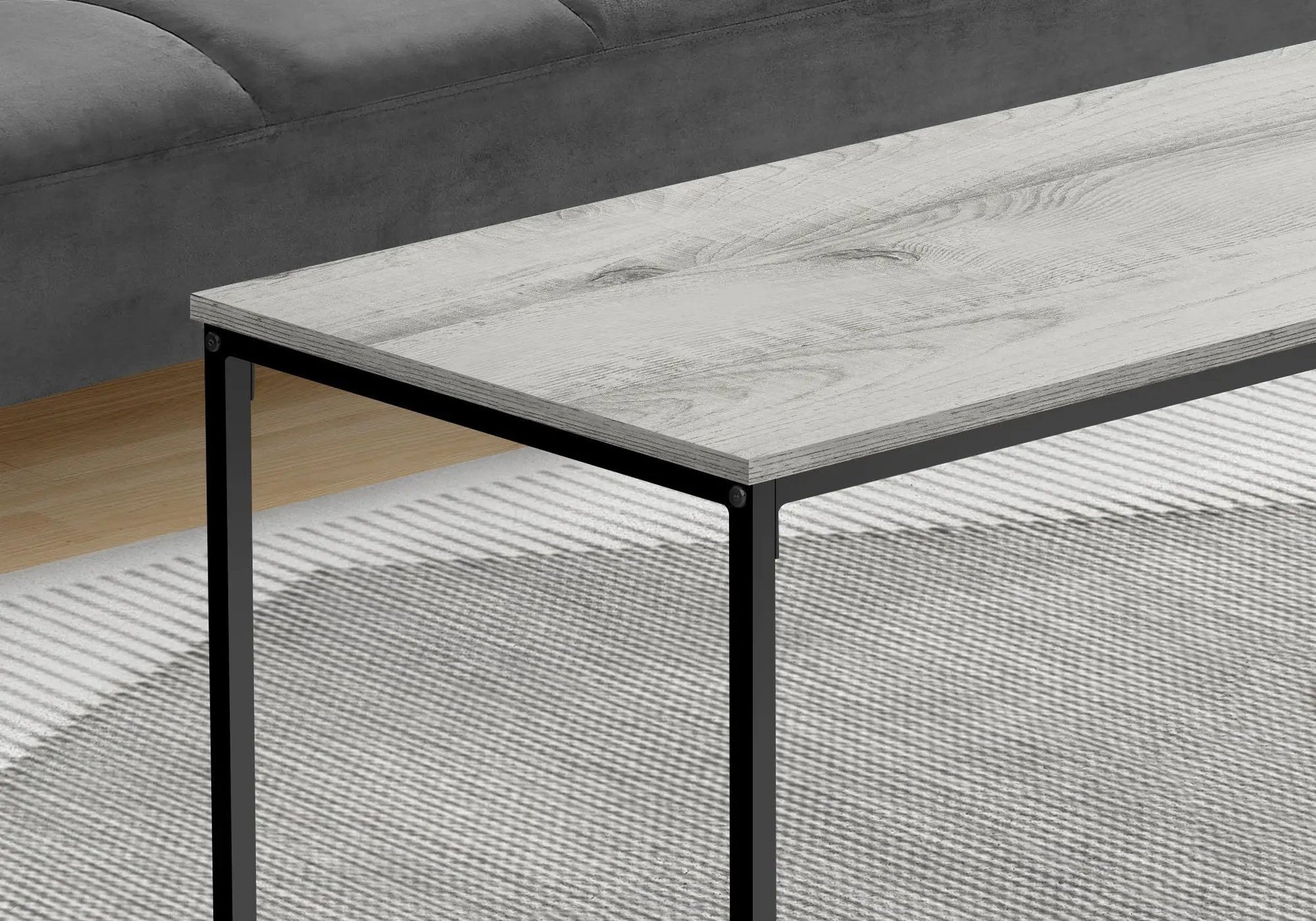 Rectangular coffee table with light gray weathered wood top and black metal frame, modern design on Tampa Home & Garden Store