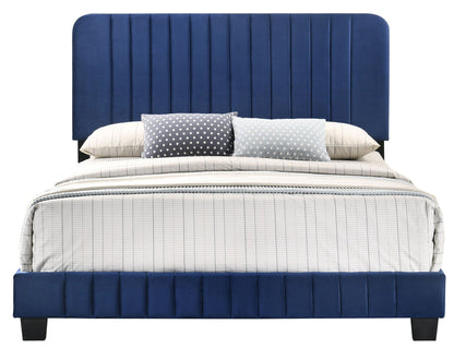 Channel tufted blue upholstered bed with striped bedding and polka dot pillows on Tampa Home & Garden Store