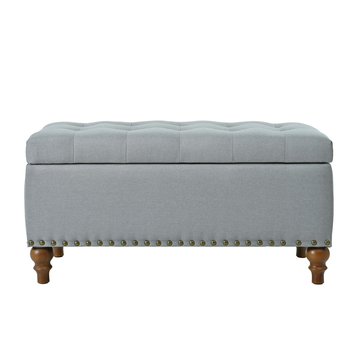Upholstered storage ottoman in gray fabric with tufted lid and rivet trim, wooden legs on Tampa Home & Garden Store