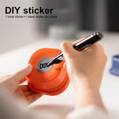 Pet communication button, orange silicone, being labeled with a round silver sticker on Tampa Home & Garden Store