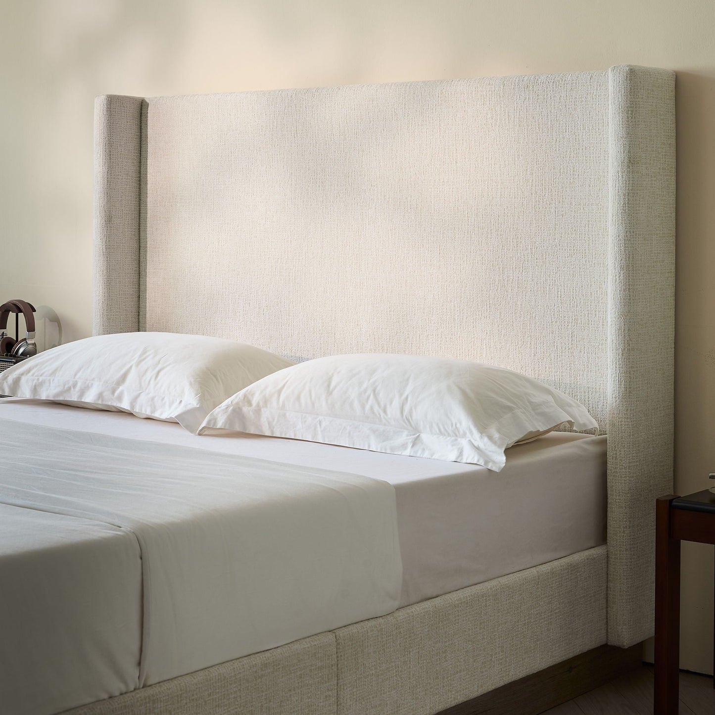 Hosford minimalist upholstered wingback bed with wood base platform in beige fabric on Tampa Home & Garden Store