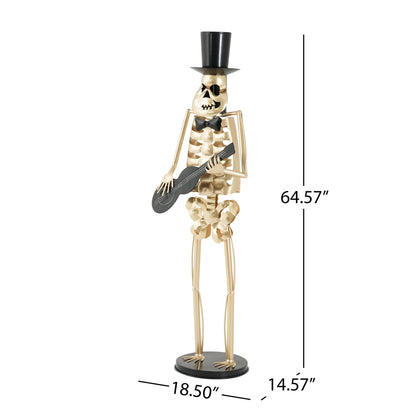 Skeleton Musician Statue in gold-tone metal with black top hat and bow tie, playing guitar on Tampa Home & Garden Store