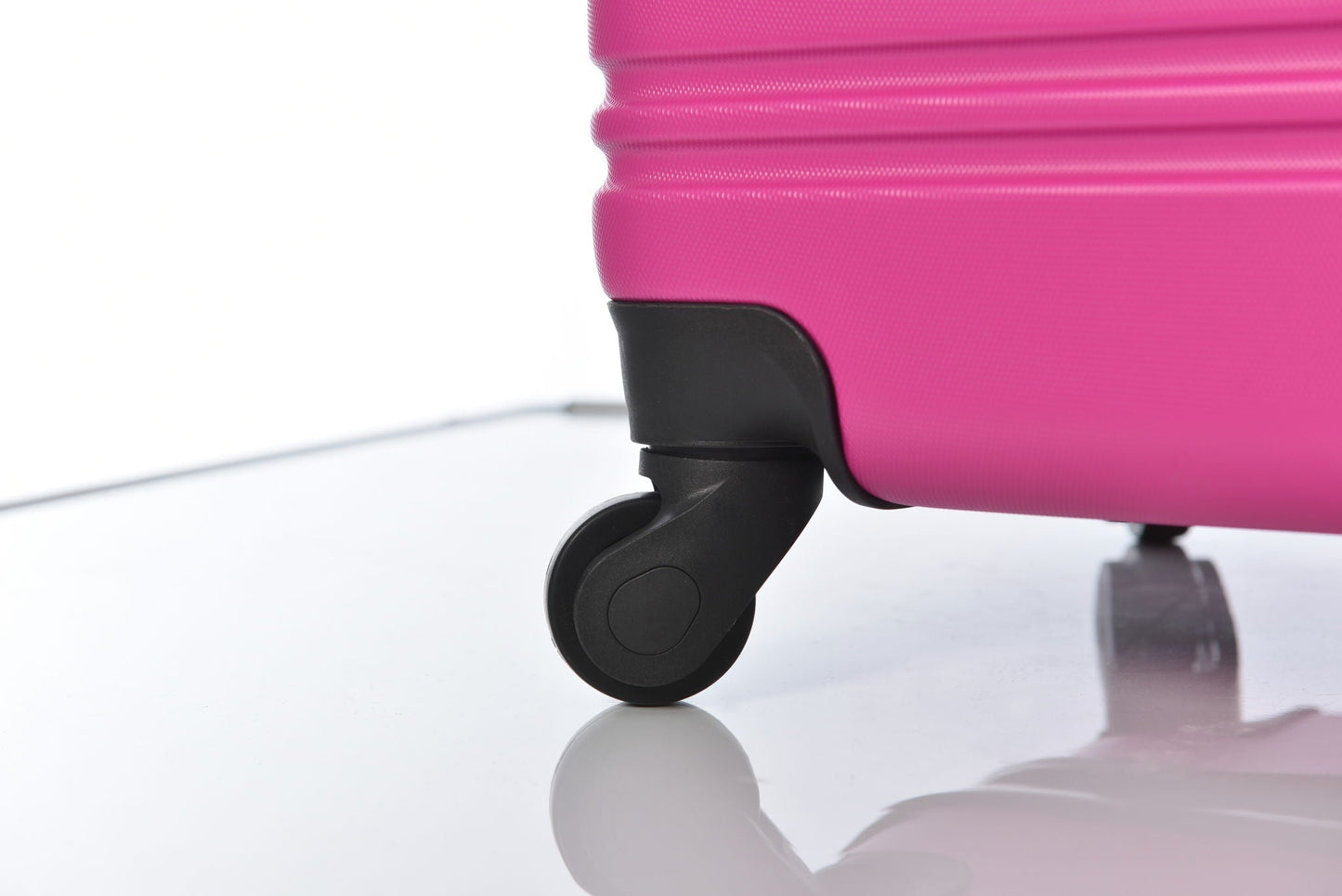 Pink HouseOfZazla hardshell luggage wheel closeup with black caster on Tampa Home & Garden Store