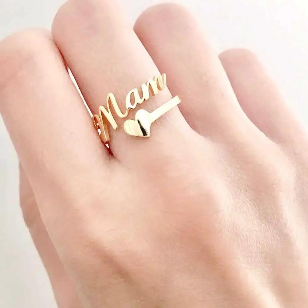 Gold-tone customized name ring with cursive lettering and heart charm, two rings on finger on Tampa Home & Garden Store