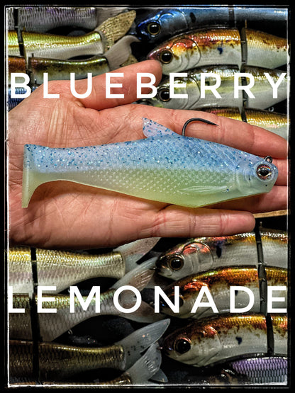 Bacca Burrito boot-tail soft swimbait in blueberry blue held in hand on display on Tampa Home & Garden Store