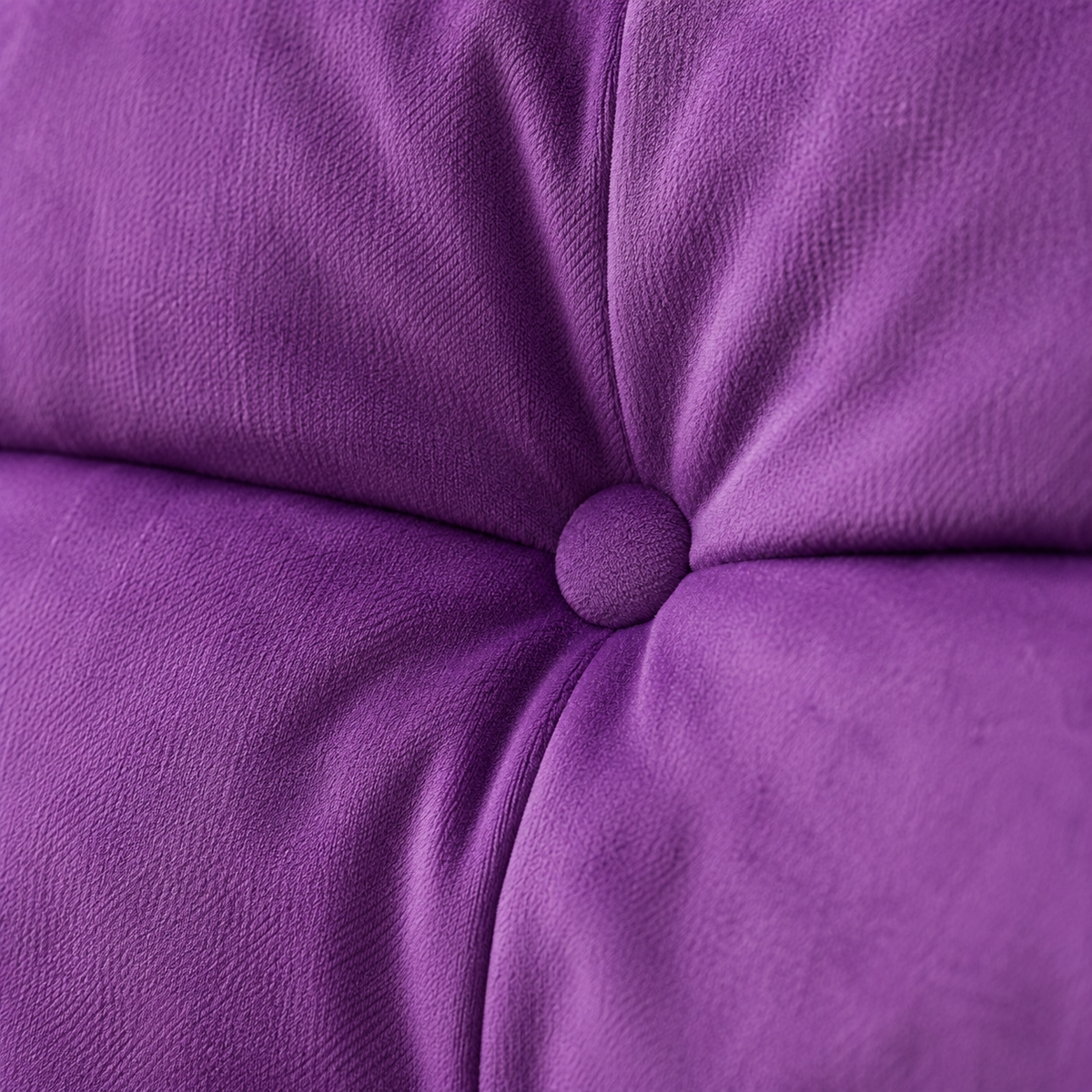Velvet purple lounge chair upholstery with central tufted button detail on Tampa Home & Garden Store