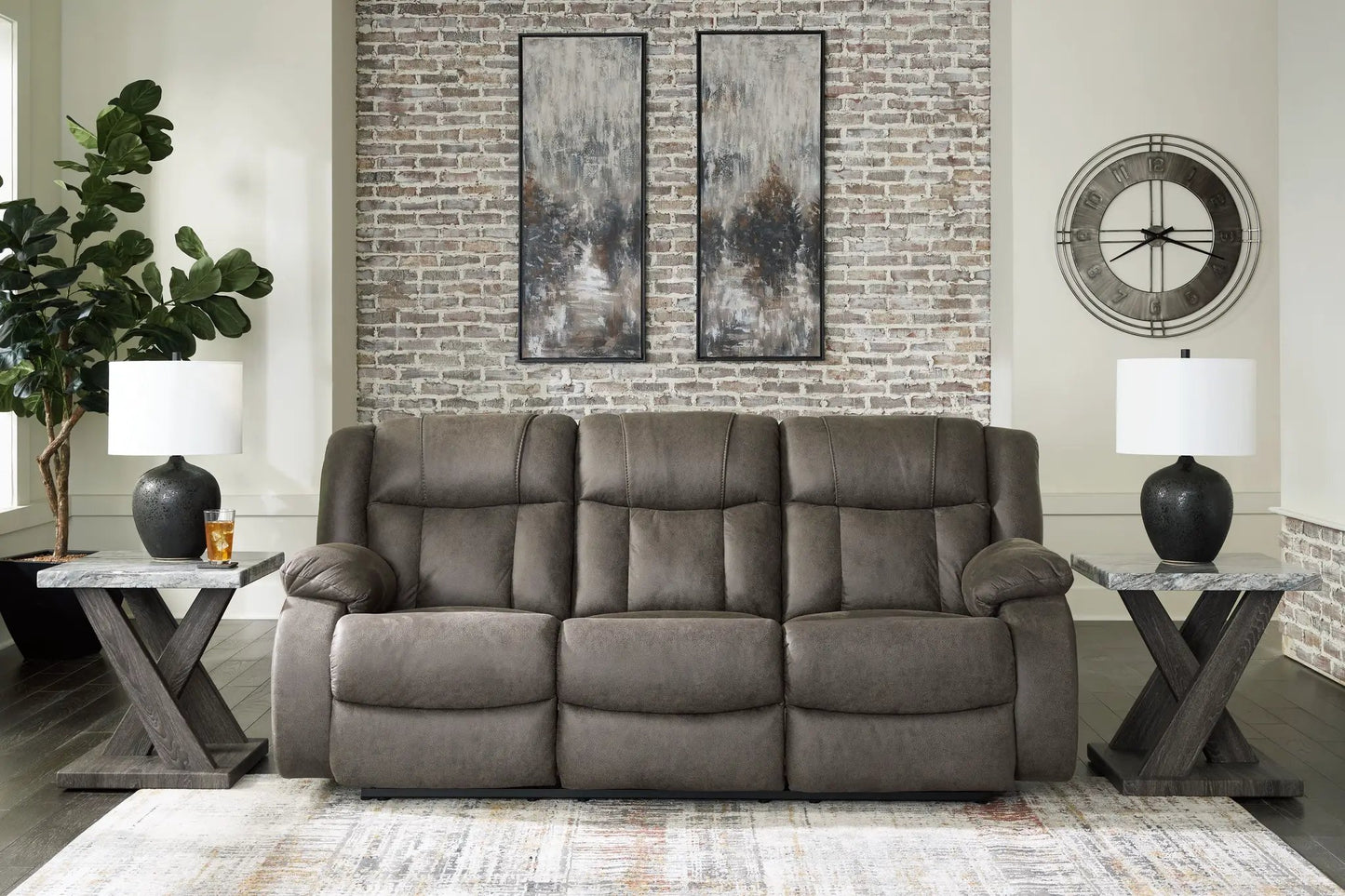 First Base Reclining Sofa Gunmetal gray fabric in a brick-wall living room with marble tables on Tampa Home & Garden Store