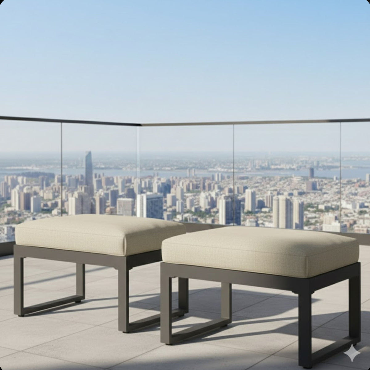 Ottomans pair with thick beige cushions on a metal frame rooftop patio view on Tampa Home & Garden Store