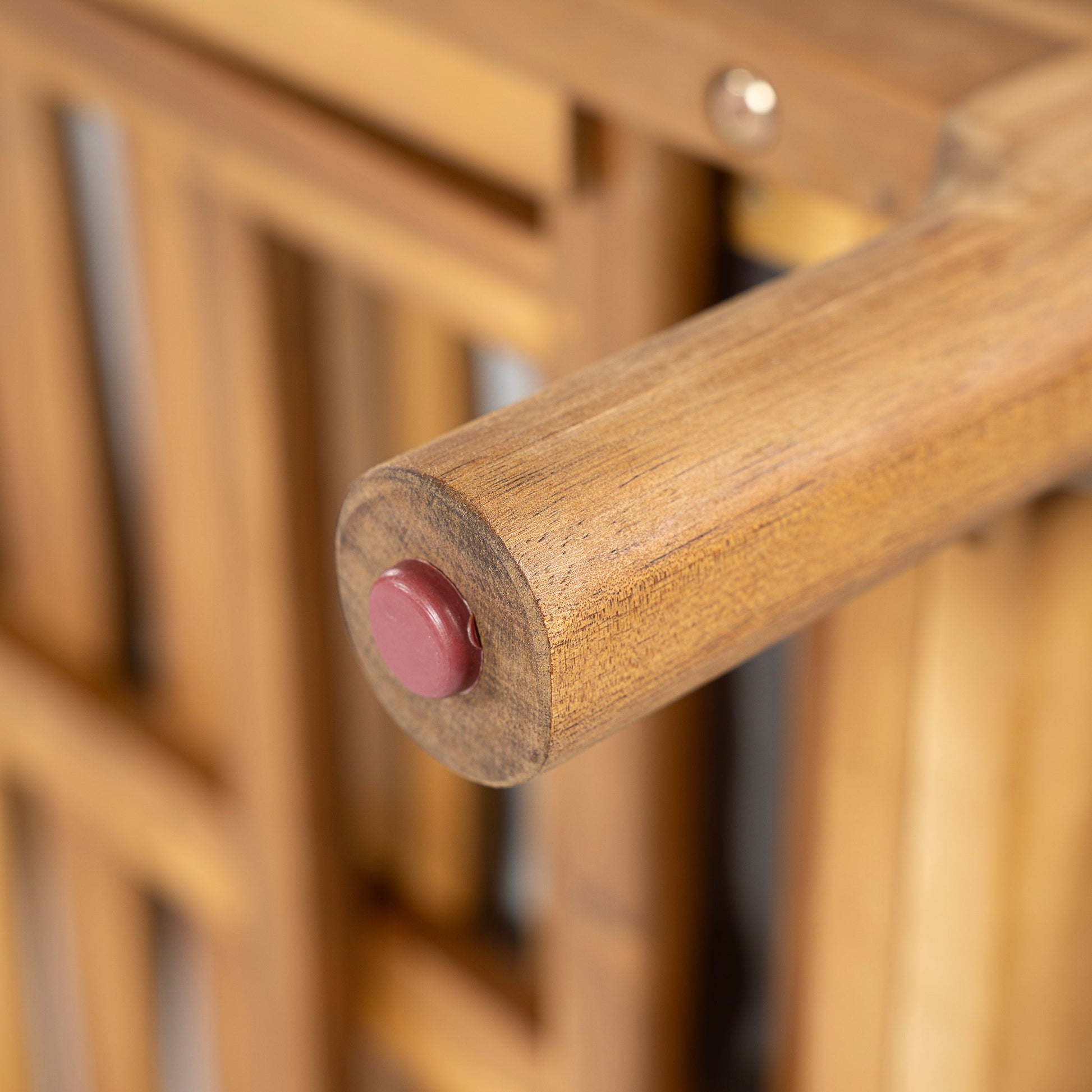 Solid acacia wood sun lounger close-up showing natural brown finish and red round end cap on Tampa Home & Garden Store