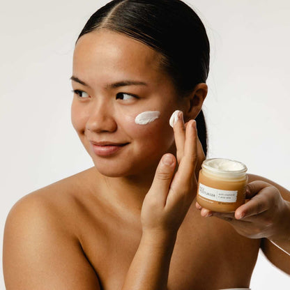 UpCircle Face Moisturiser jar amber with white lid; vitamin E; applying cream to cheek on Tampa Home & Garden Store