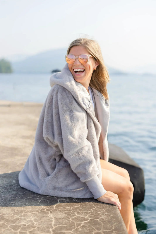 Waterproof Cardigan Outdoors by Pretty Rugged, light-gray hooded outerwear worn by woman on Tampa Home & Garden Store