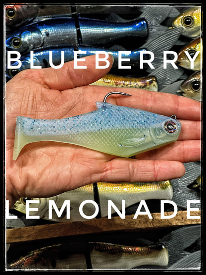 Bacca Burrito boot tail soft swimbait blueberry blue by Bull Shad Swimbaits held in hand on Tampa Home & Garden Store