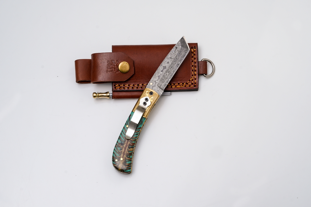 Damascus Tanto Folder with teal pine cone handle and engraved brass bolster by Titan Intl K on Tampa Home & Garden Store