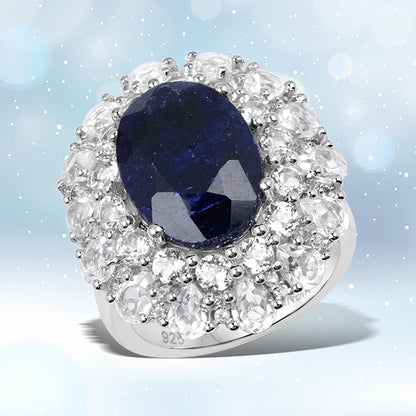 Sterling silver ring with oval blue dyed sapphire center surrounded by a halo of topaz on Tampa Home & Garden Store