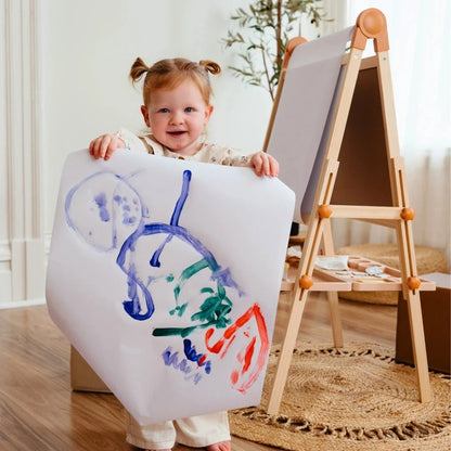 Tiny Land Caramel Magnitales Kids Easel with wooden A-frame, child holds colorful drawing on Tampa Home & Garden Store