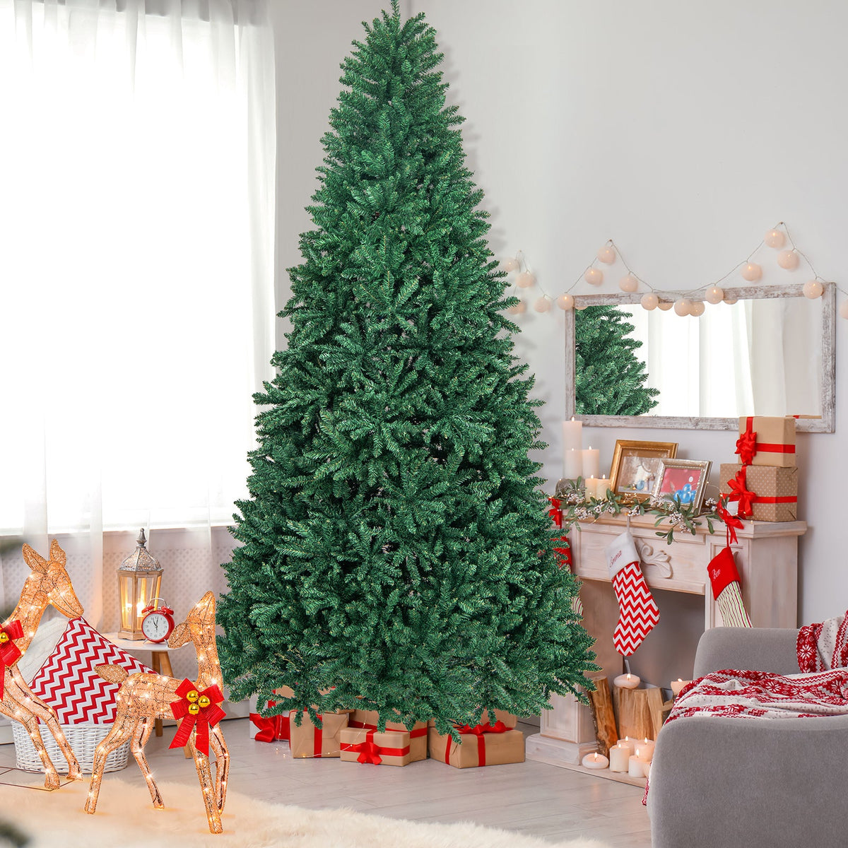 9 ft hinged artificial PVC Christmas tree with solid metal stand in a festive living room on Tampa Home & Garden Store