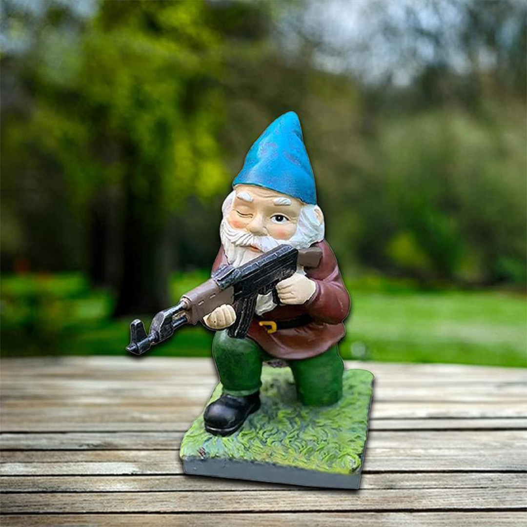 Military Garden Gnome Statue with blue hat, brown coat, holding rifle on a green base on Tampa Home & Garden Store