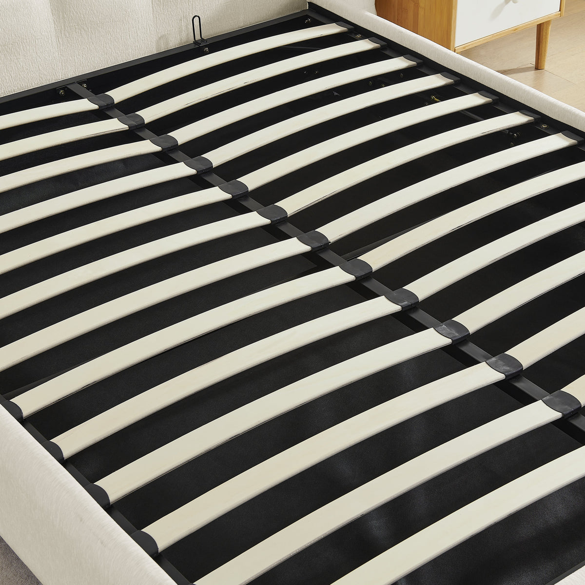 Queen size bed frame with beige chenille wingback headboard and white slatted support on Tampa Home & Garden Store