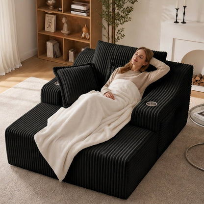 Comfortable Oversized Chaise Lounge and Bed in black ribbed fabric with a person resting on Tampa Home & Garden Store