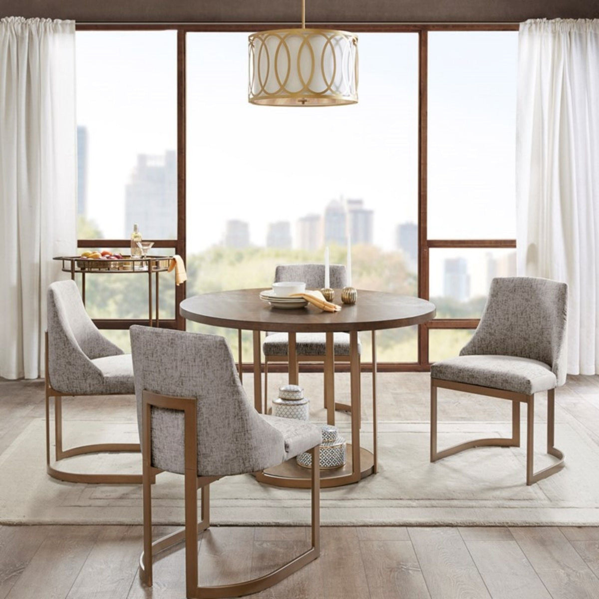 Modern dining chairs with gray upholstered cushions around a round wood table on Tampa Home & Garden Store