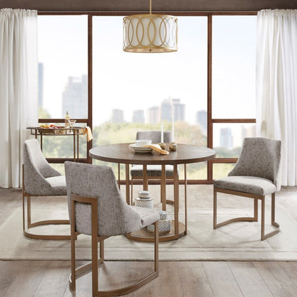 Modern dining chairs with gray upholstered cushions around a round wood table on Tampa Home & Garden Store