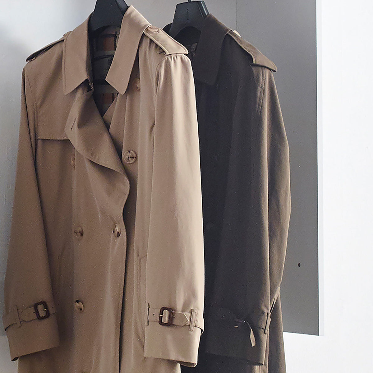 Wall mounted wood wardrobe system with modular units; beige and brown trench coats on hangers on Tampa Home & Garden Store