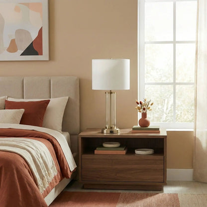 Luna table lamp with clear glass body, brass base, white shade on bedside table on Tampa Home & Garden Store
