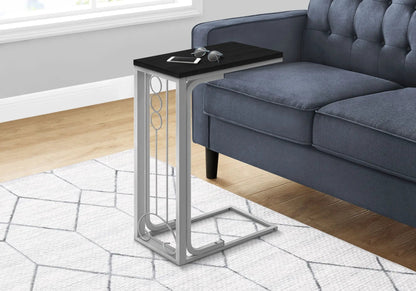 Elegant C-shaped accent table with dark wood top and gray metal frame beside a blue sofa on Tampa Home & Garden Store