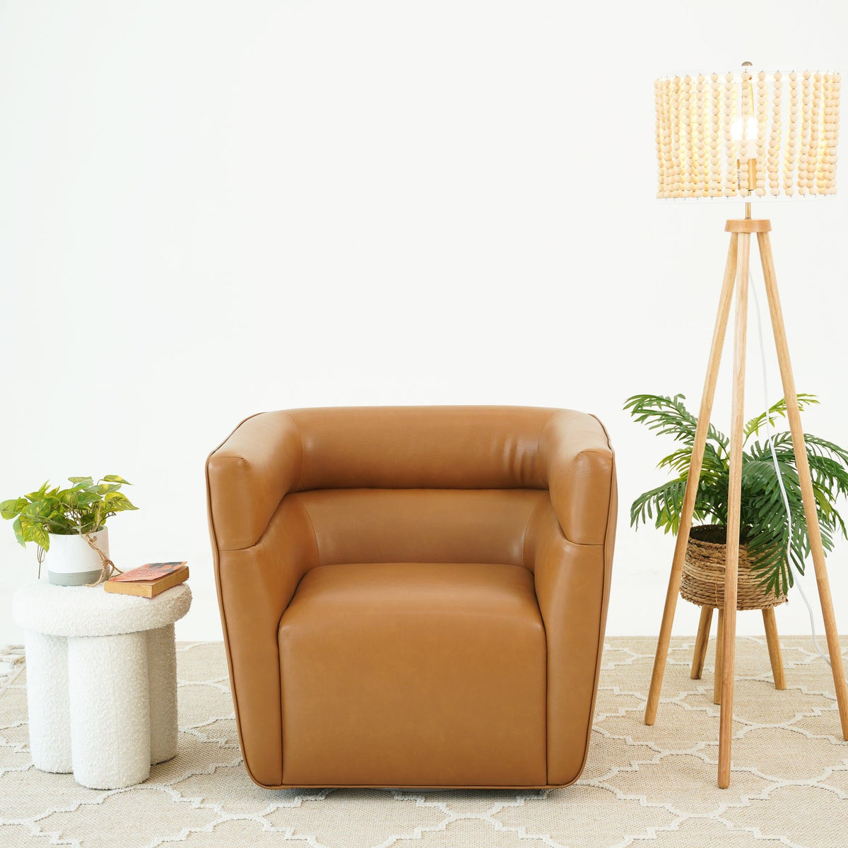 Tan genuine leather swivel armchair with rounded arms and plush cushion on Tampa Home & Garden Store
