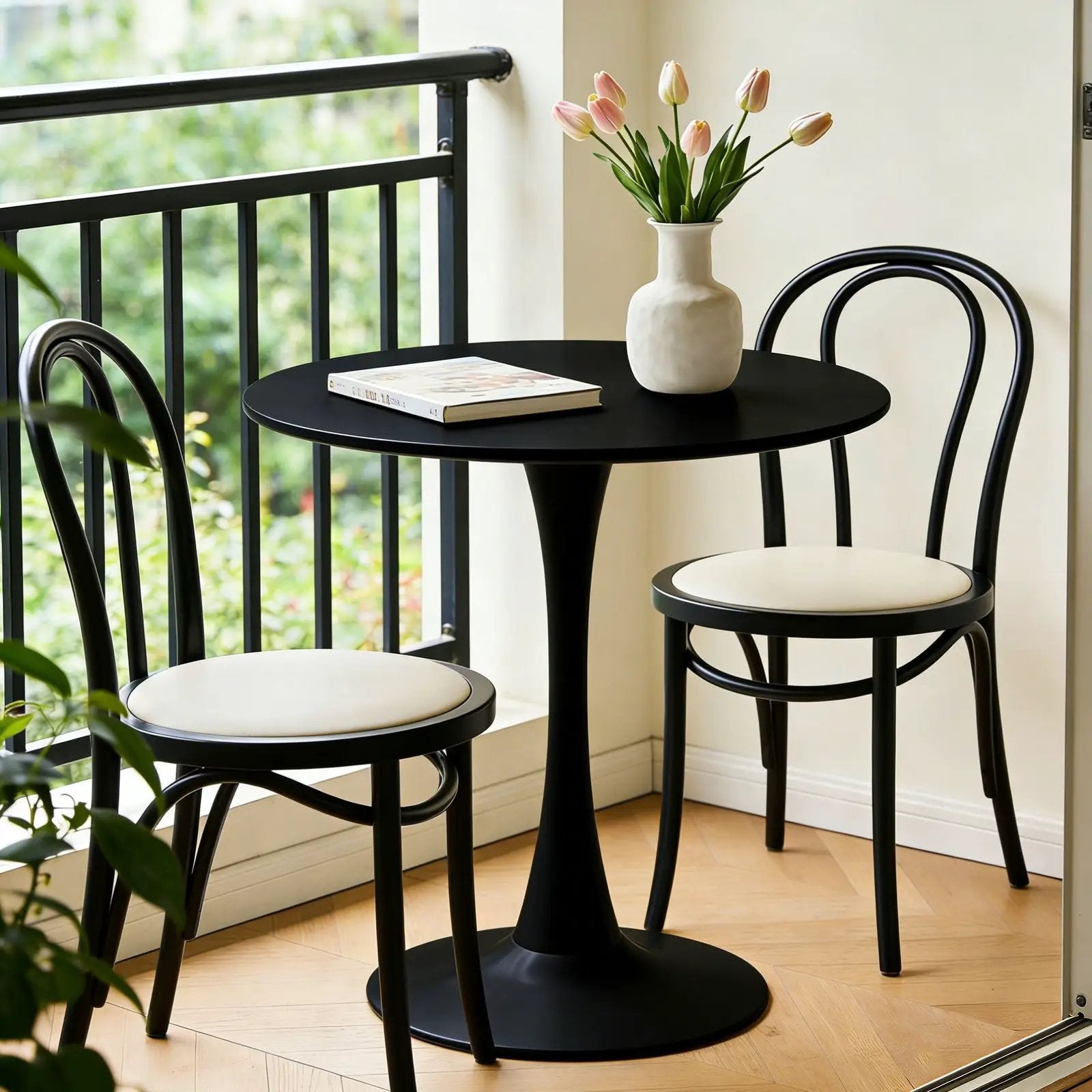 Round Dining Table Tulip-Base Black; black chairs white cushions; pink tulip vase on Tampa Home & Garden Store