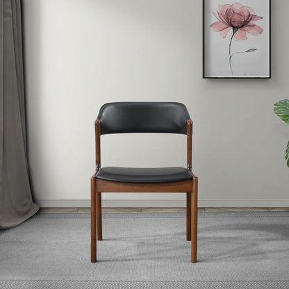 Enzo dining chair with black vegan leather upholstery and brown wooden legs on Tampa Home & Garden Store