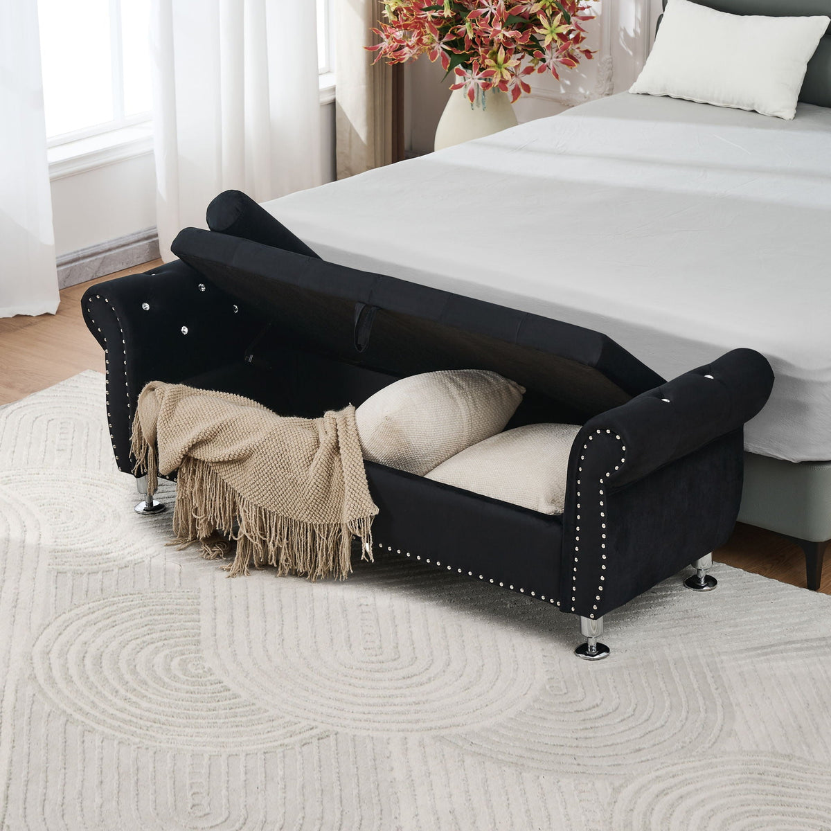 Storage bench with crystal button studs, black upholstery; beige throw and pillow on bed on Tampa Home & Garden Store