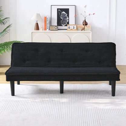 Versatile black futon sofa bed in ribbed fabric with slim legs against a white cabinet with lamp on Tampa Home & Garden Store