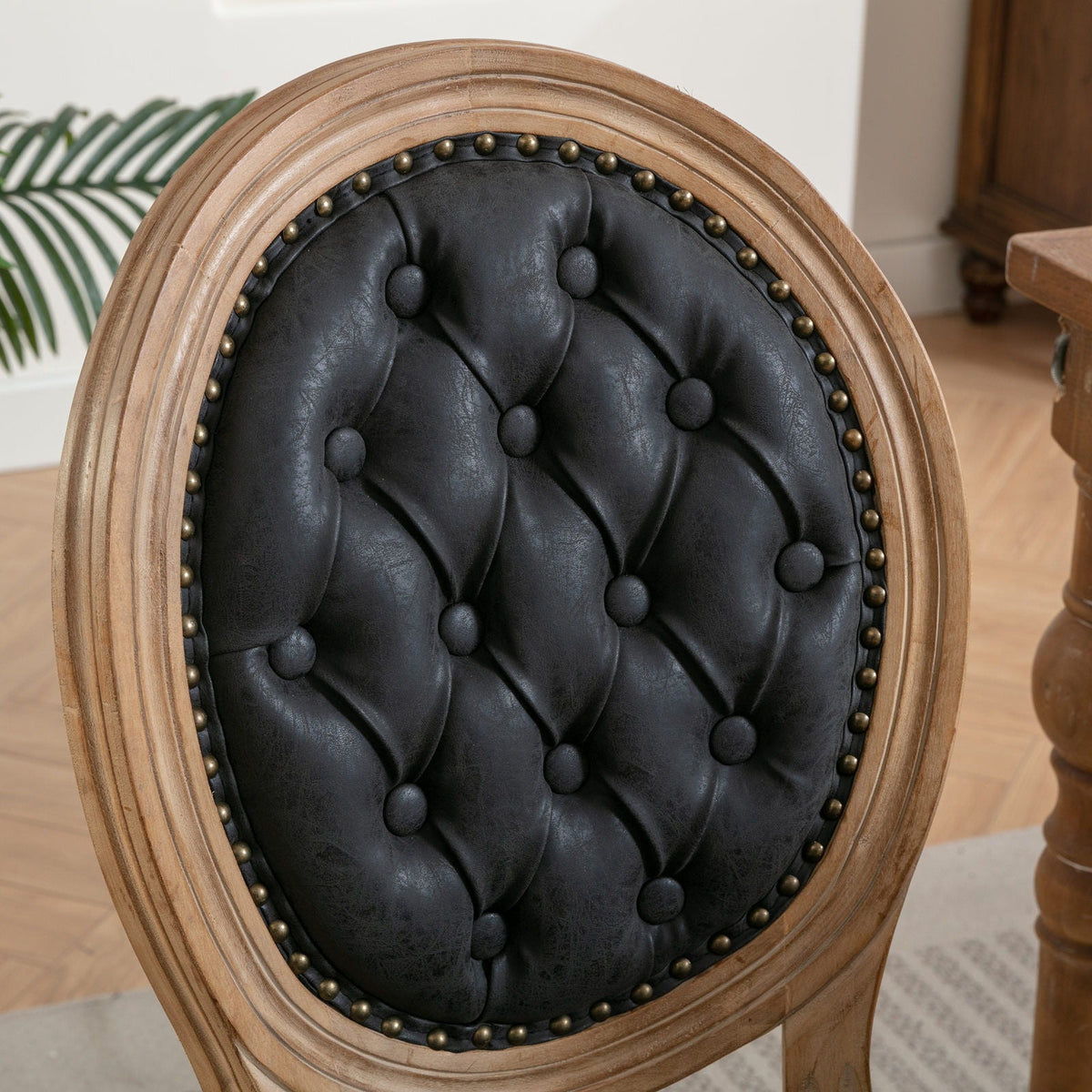 French style solid wood dining chair with black tufted upholstery and brass nailhead trim on Tampa Home & Garden Store