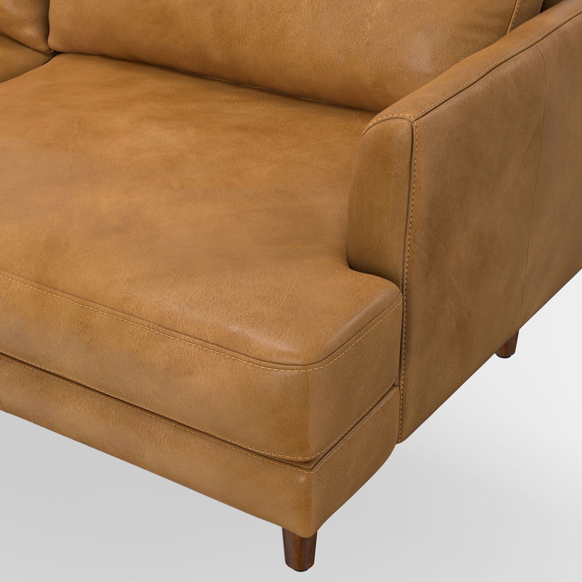 Livingston Upholstered Sofa in tan leather with stitching and wooden leg on Tampa Home & Garden Store