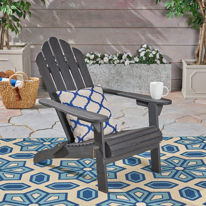 Hollywood Adirondack chair by HouseOfZazla in charcoal gray on stone patio with a blue rug on Tampa Home & Garden Store