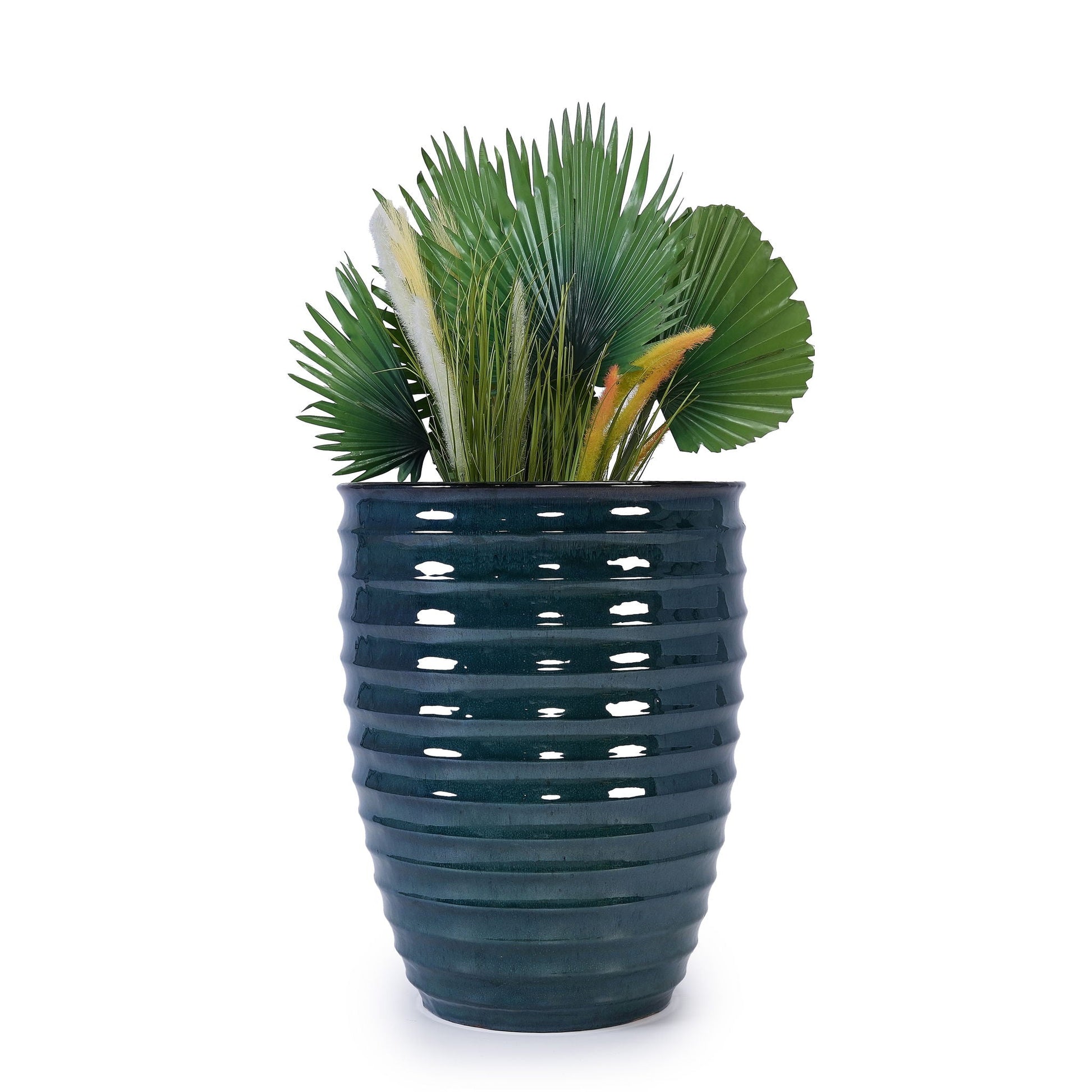 Blue ceramic planter with ribbed texture filled with green palm leaves and pampas grass on Tampa Home & Garden Store