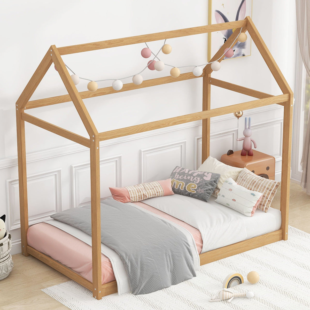 Wooden house-shaped bunk bed frame in natural oak with pastel ball lights on headboard on Tampa Home & Garden Store
