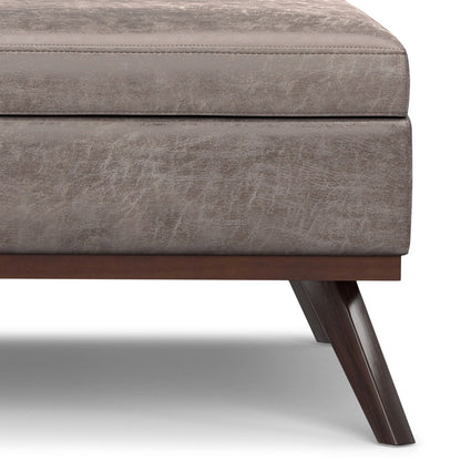 Square lift-top coffee table and storage ottoman in taupe faux leather with dark wood legs on Tampa Home & Garden Store